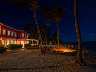 The Lodge at night chilling by the fire pit PH Hatch Magazine scaled